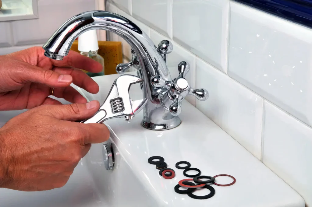 Plumber performing maintenance on a bathroom faucet in Casselberry