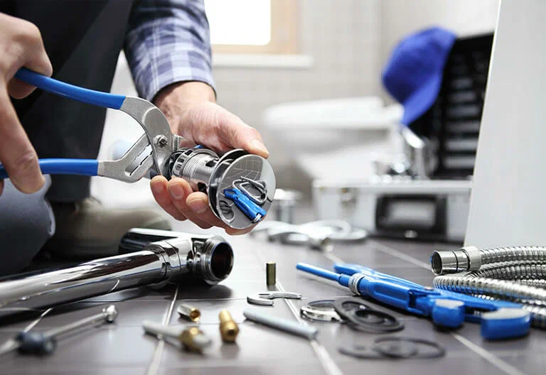 Technician repairing a plumbing fixture with professional tools in Casselberry