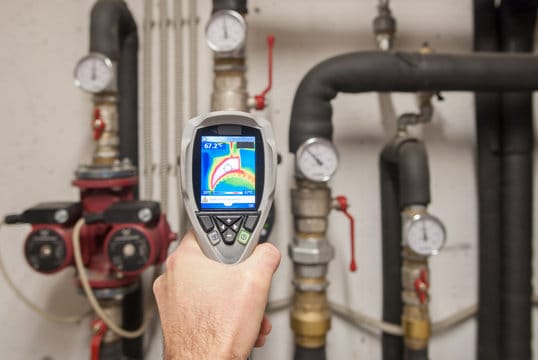 Plumber using a thermal imaging camera to inspect pipes in Casselberry