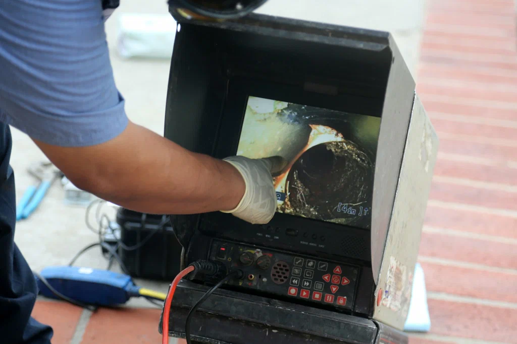 Technician viewing a drain inspection camera in Casselberry