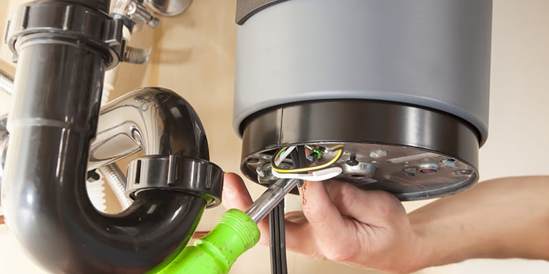 Technician repairing the heating element of a water heater in Casselberry