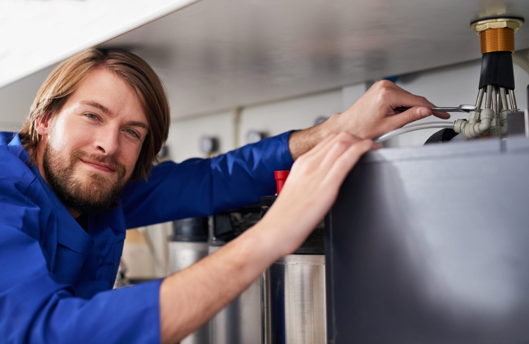 Technician servicing a residential water heater tank in Casselberry